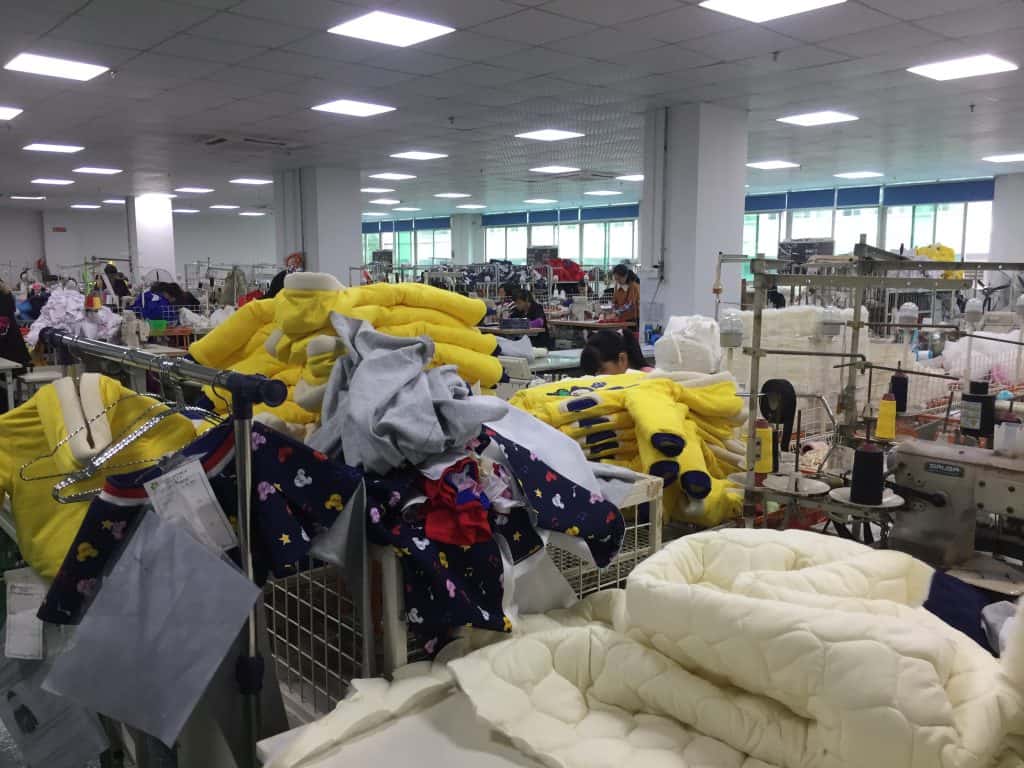 Interior of a clothing manufacturing factory with custom private label apparel production.